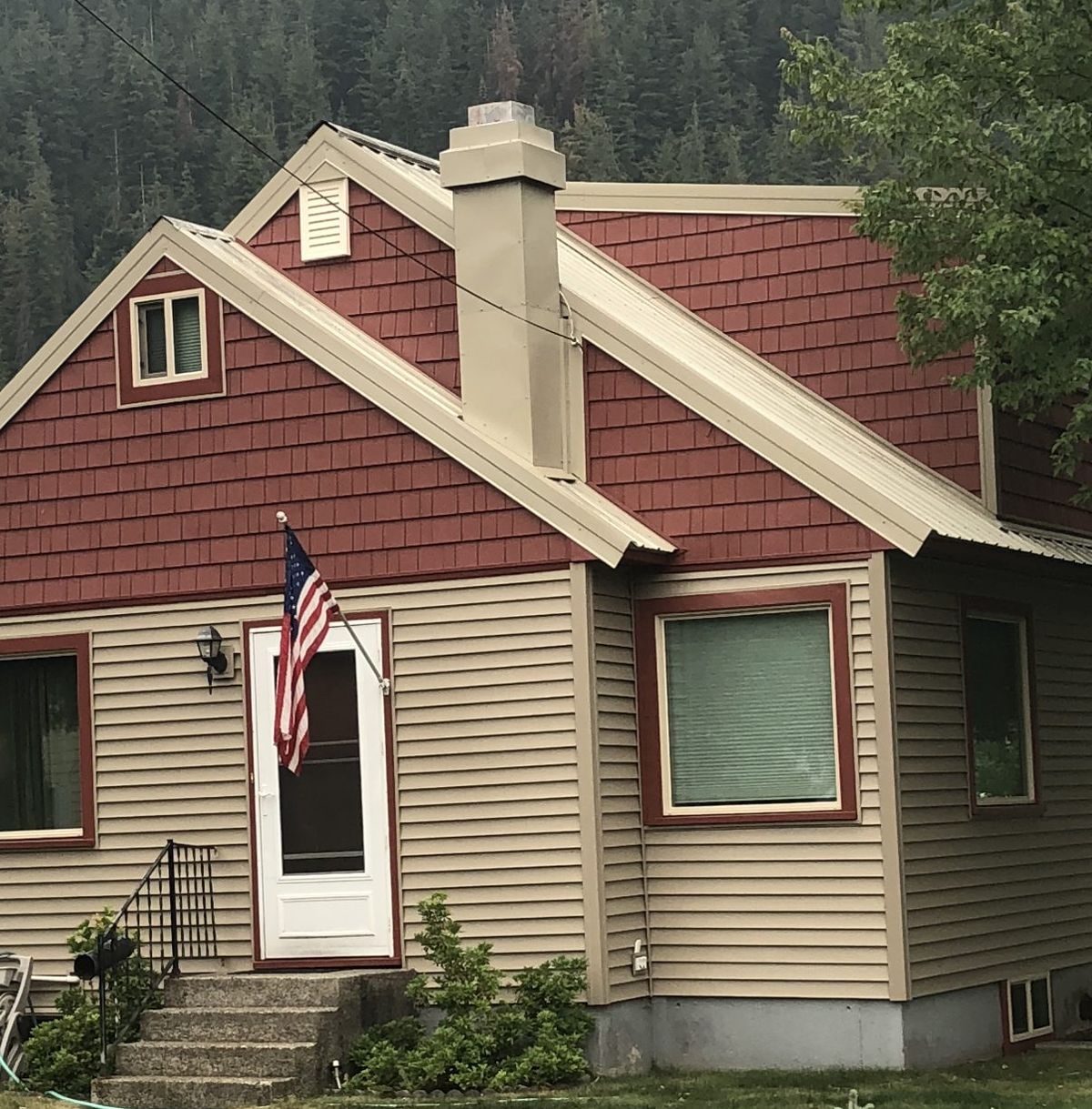 Home with lifetime warranty vinyl siding, red vinyl gable shingles, custom red metal window and door wraps and a metal roof
