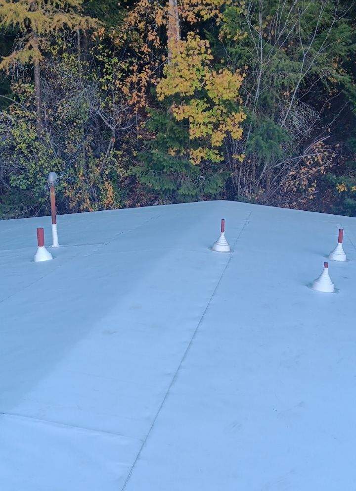 TPO single ply insulated membrane roof on a shallow pitch building with sealed vent boots