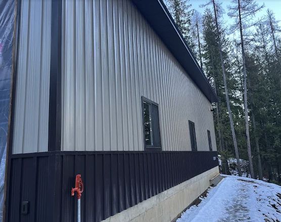 Metal siding and trim detail on the side of a building