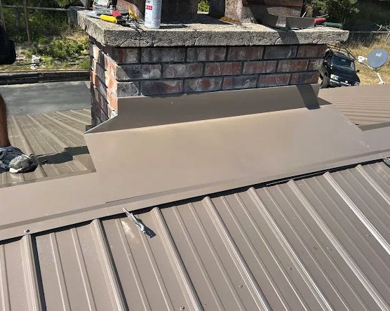 Standing seam metal roof with new chimney flashing